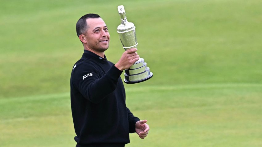 Xander Schauffele poses with the Claret Jug