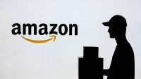 ANKARA, TURKIYE – JULY 4: In this photo illustration a man carrying a package in front of the Amazon logo in Ankara, Turkiye on July 4, 2024. (Photo by Dilara Irem Sancar/Anadolu via Getty Images)