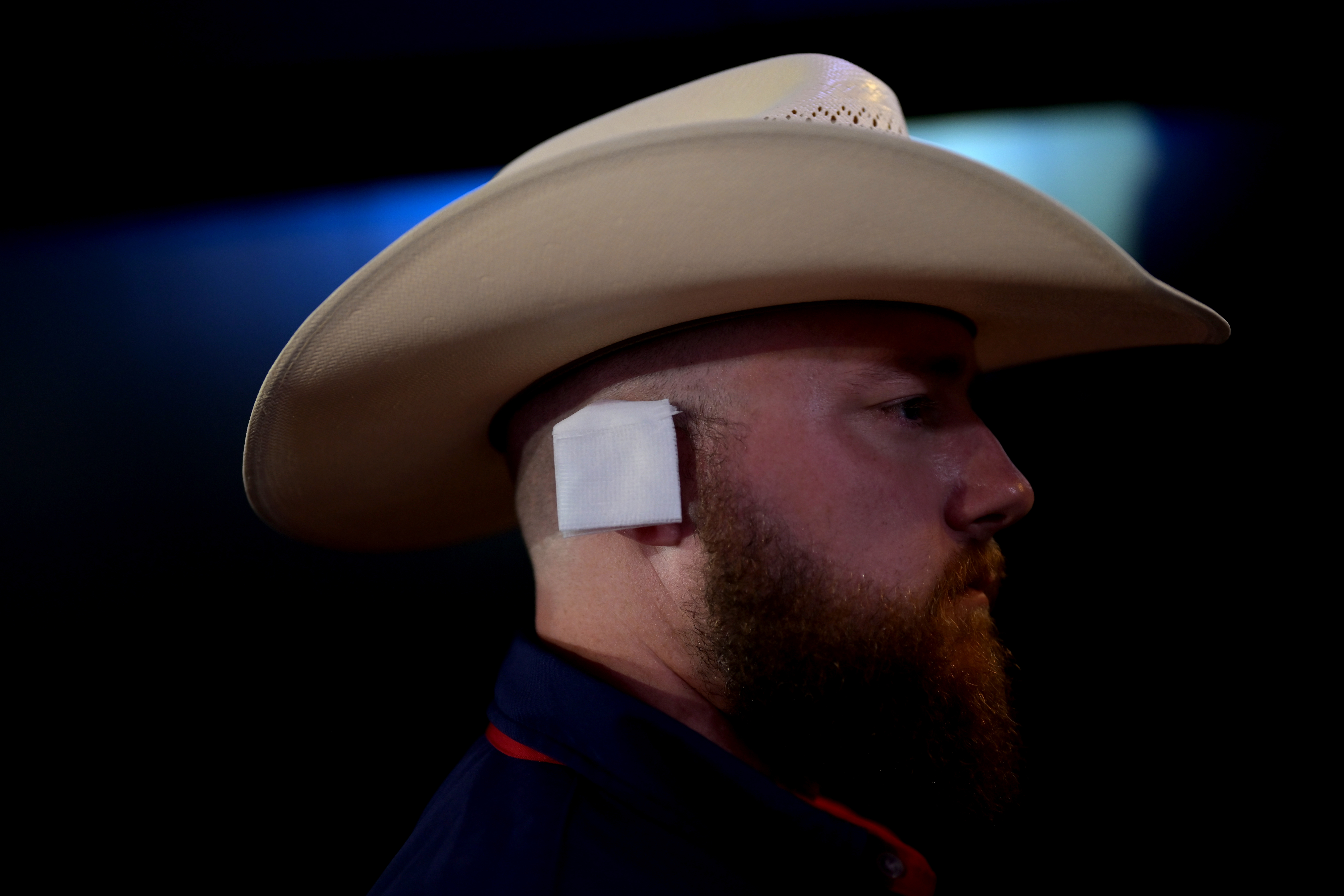 A delegate wears an imitation ear bandage during the Republican National Convention (RNC) at the Fiserv Forum in Milwaukee, Wisconsin, US, on Wednesday, July 17, 2024. The RNC chairman warned against complacency when his party concludes its official nominating jamboree this week with polls predicting ex-President Donald Trump prevailing over President Joe Biden in the November election. Photographer: Victor J. Blue/Bloomberg via Getty Images