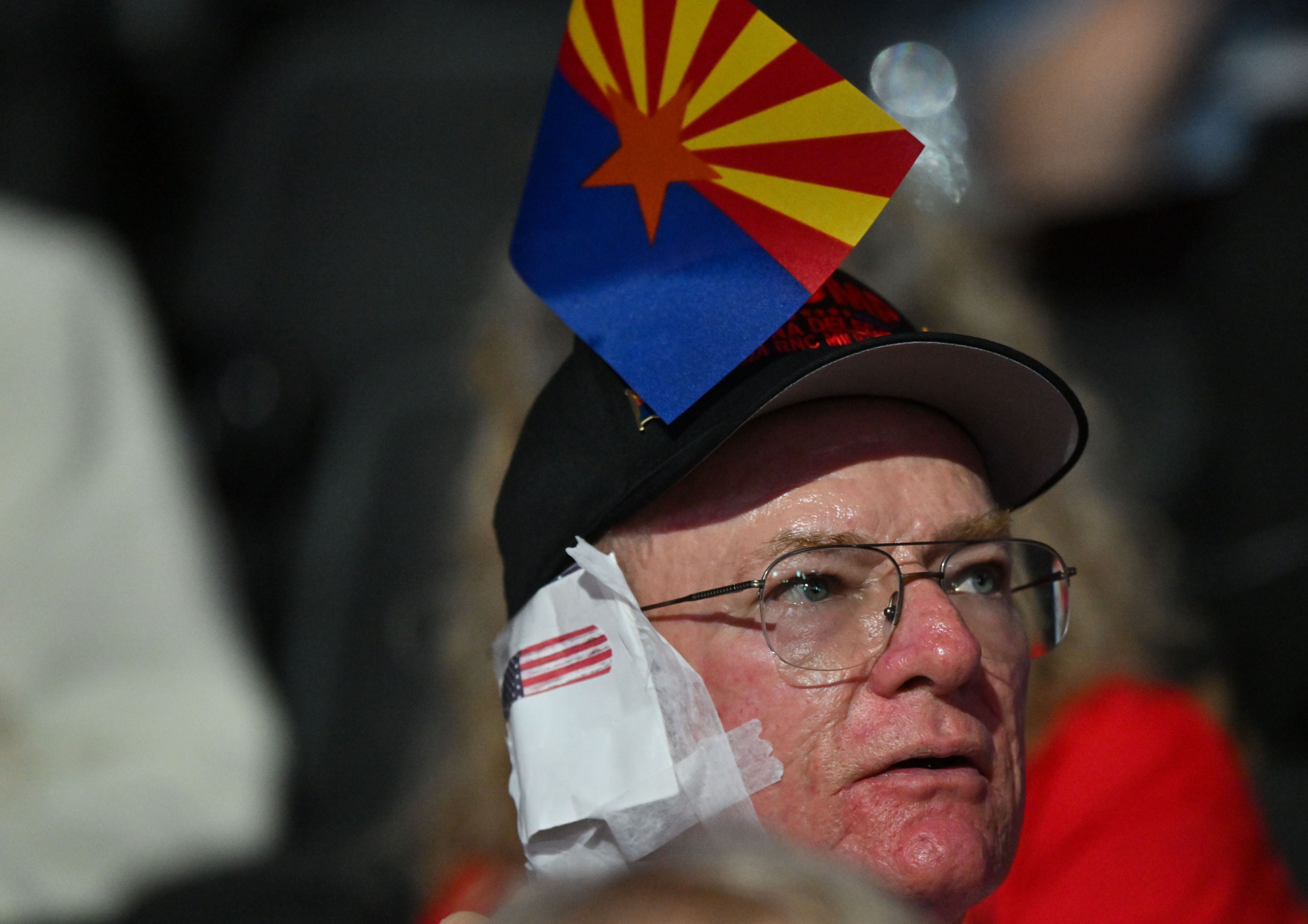 MILWAUKEE, WI – JULY 17: An attendee wears a bandage on his ear in solidarity with former president Donald Trump during Day 3 of the Republican National Convention on July 17, 2024 in Milwaukee, WI. Former President Donald Trump is the Republican presidential candidate and will address the convention on Thursday. (Photo by Ricky Carioti/The Washington Post via Getty Images)