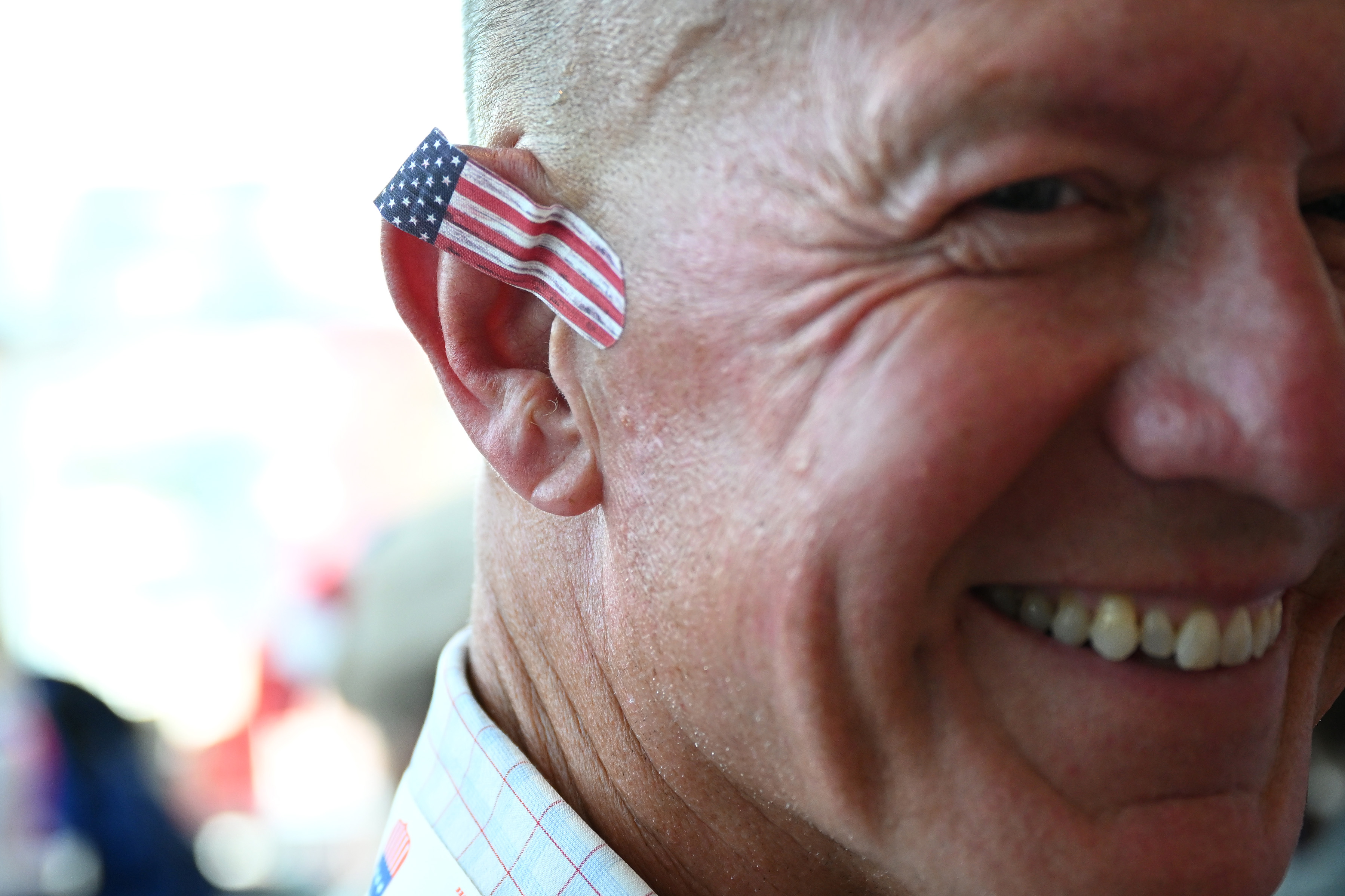 MILWAUKEE, WISCONSIN – JULY 15: A person has a American flag bandaid on his ear on the first day of the Republican National Convention at the Fiserv Forum on July 15, 2024 in Milwaukee, Wisconsin. Delegates, politicians, and the Republican faithful are in Milwaukee for the annual convention, concluding with former President Donald Trump accepting his party’s presidential nomination. The RNC takes place from July 15-18. (Photo by Leon Neal/Getty Images)