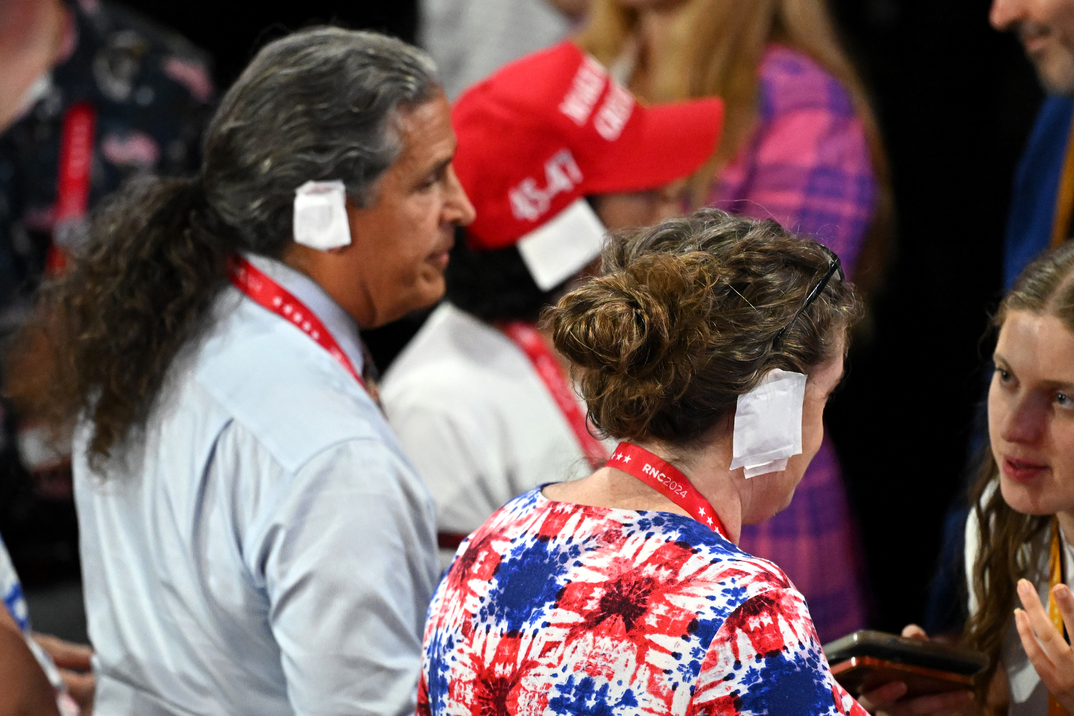 MILWAUKEE, WISCONSIN – JULY 17: People wear “bandages” on their ears on the third day of the Republican National Convention at the Fiserv Forum on July 17, 2024 in Milwaukee, Wisconsin. Delegates, politicians, and the Republican faithful are in Milwaukee for the annual convention, concluding with former President Donald Trump accepting his party’s presidential nomination. The RNC takes place from July 15-18.  (Photo by Leon Neal/Getty Images)