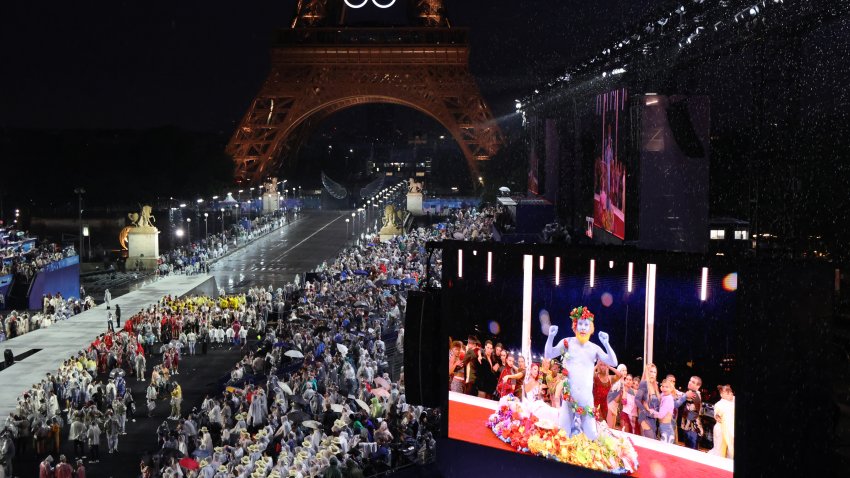 Delegations arrive at the Trocadero as spectators watch French singer Philippe Katerine performing on a giant screen during the Opening Ceremony of the Olympic Games Paris 2024 on July 26, 2024 in Paris, France.