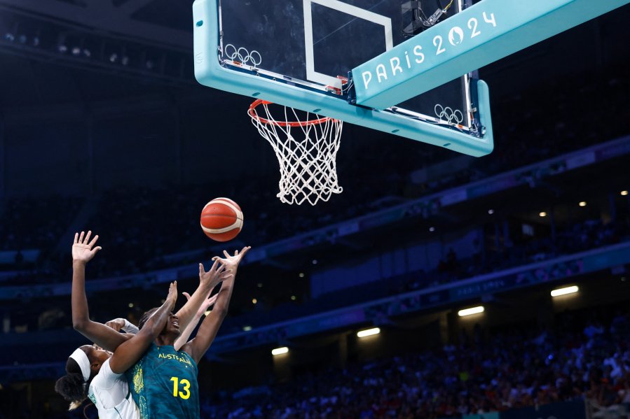 Australia's #13 Ezi Magbegor defends against Nigeria's #03 Pallas Kunaiyi-Akpanah (L) in the women's preliminary round group B basketball match between Nigeria and Australia during the Paris 2024 Olympic Games.