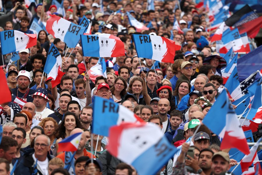 Spectators wave flags