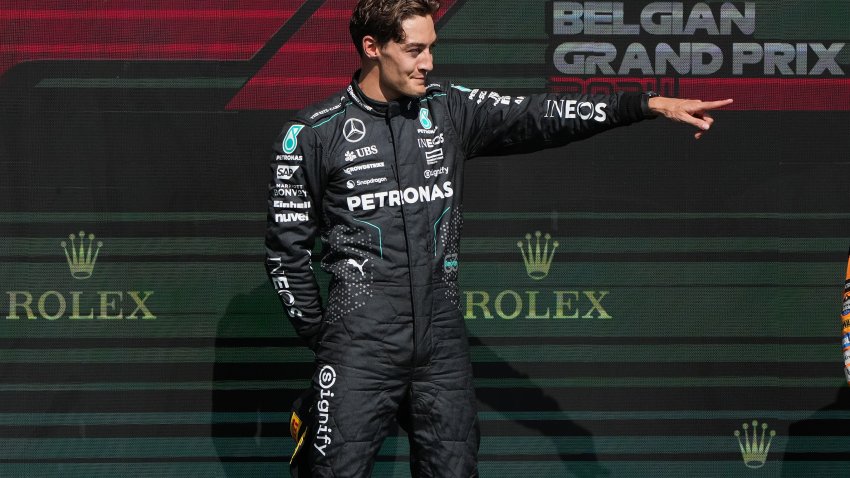 SPA, BELGIUM – JULY 28: 1st placed finisher George Russell of Great Britain and Mercedes, later disqualified for a car weight infraction, celebrates on the podium during the F1 Grand Prix of Belgium at Circuit de Spa-Francorchamps on July 28, 2024 in Spa, Belgium. (Photo by Alex Bierens de Haan/Getty Images)