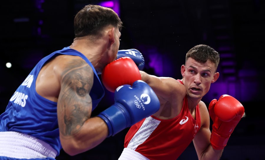 Harry Garside of Team Australia punches Richard Kovacs of Team Hungary during the Men's 63.5kg preliminary round match between Harry Garside of Team Australia and Richard Kovacs of Team Hungary on day three of the Olympic Games.