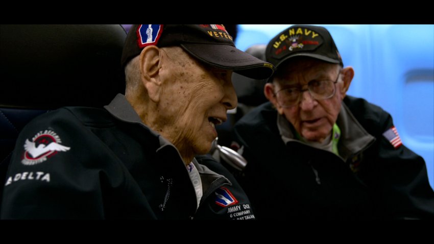 Veterans talk to each other on an airplane