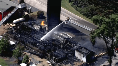 Aerial footage shows suburban barn burnt to the ground as firefighters work to put out blaze