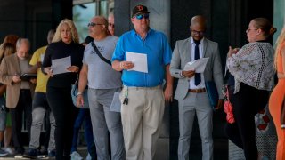 People line up as they wait for the JobNewsUSA.com South Florida Job Fair to open at the Amerant Bank Arena on June 26, 2024, in Sunrise, Florida. 