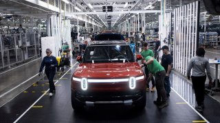 Workers assemble second-generation R1 vehicles at electric auto maker Rivian’s manufacturing facility in Normal, Illinois, U.S. June 21, 2024.