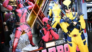 Cosplayers pose for a photo in front of a life-size model of the new Marvel Universe movie “Deadpool & Wolverine,” authorized by Disney and seen in Shanghai, China, on July 26, 2024.