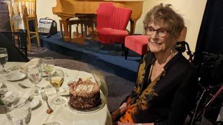 Babette Hughes celebrates her 100th birthday with a cake.