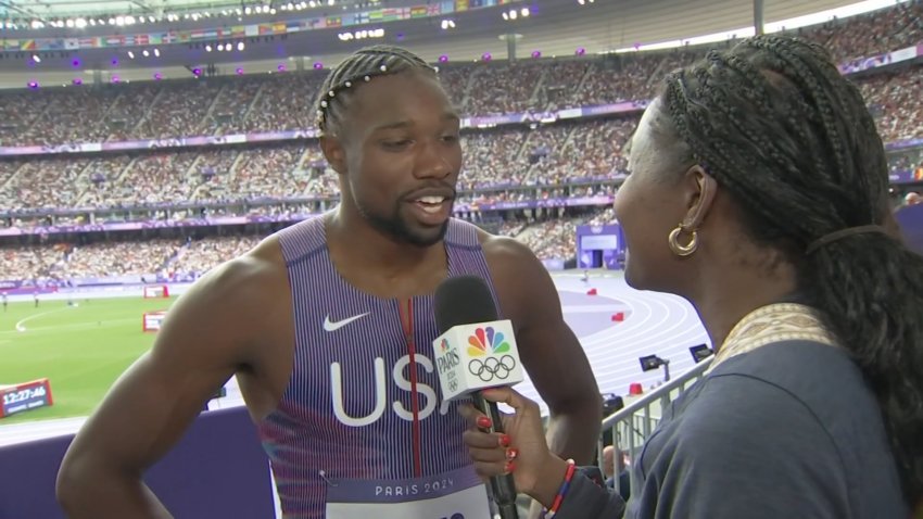 Noah Lyles speaks to a reporter after his race