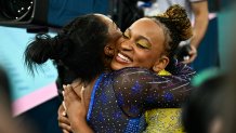 Winner US' Simone Biles (L) hugs second-placed Brazil's Rebeca Andrade at the end of the artistic gymnastics women's all around final of the Paris 2024 Olympic Games at the Bercy Arena in Paris, on August 1, 2024. (Photo by Loic VENANCE / AFP) (Photo by LOIC VENANCE/AFP via Getty Images)