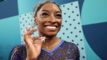 PARIS, FRANCE - AUGUST 01: Gold medalist Simone Biles of Team United States poses with a necklace in the likeness of a goat after competing in the Artistic Gymnastics Women's All-Around Final on day six of the Olympic Games Paris 2024 at Bercy Arena on August 01, 2024 in Paris, France. (Photo by Jamie Squire/Getty Images)