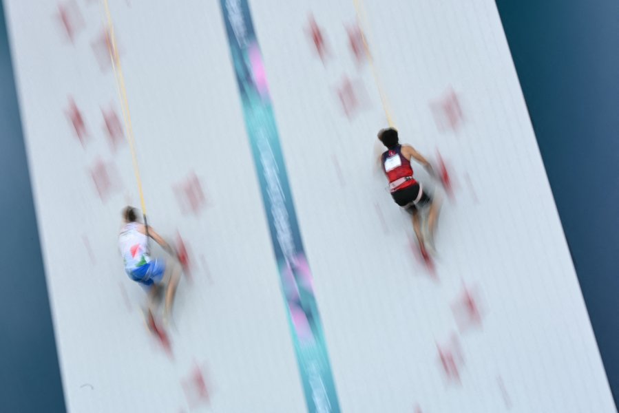 China's Wu Peng and Italy's Matteo Zurloni compete in a men's sport climbing speed quarter-final during the Paris 2024 Olympic Games at Le Bourget Sport Climbing Venue in Le Bourget on August 8, 2024