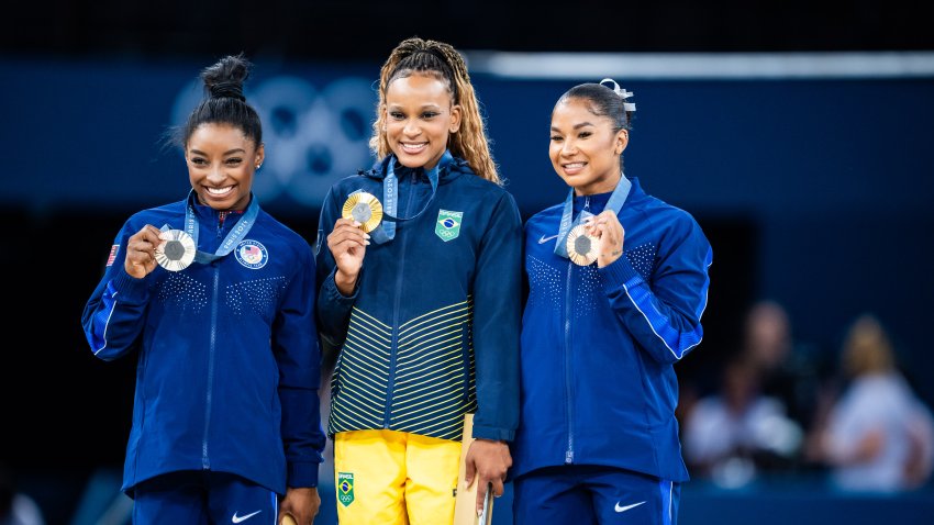 PARIS, FRANCE – AUGUST 5: Silver medalist Simone Biles of Team United States, Gold medalist Rebeca Andrade of Team Brazil and Bronze medalist Jordan Chiles of Team United States celebrate after the Artistic Gymnastics Women’s Floor Exercise Final on day ten of the Olympic Games Paris 2024 at the Bercy Arena on August 5, 2024 in Paris, France. (Photo by Tom Weller/VOIGT/GettyImages)