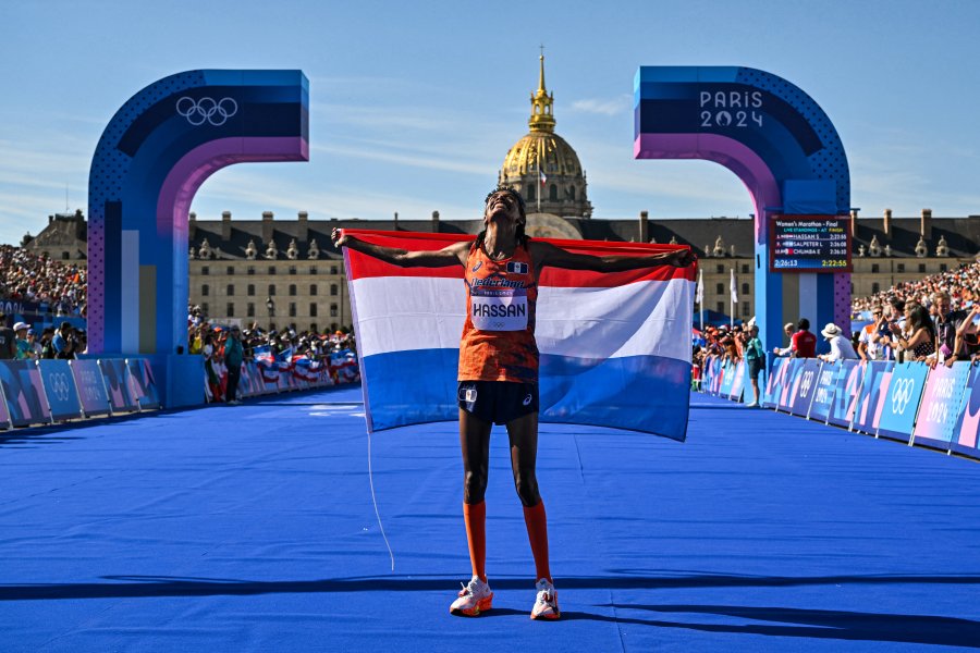 Netherlands' gold medallist Sifan Hassan celebrates after crossing the finish in first place in the women's marathon of the athletics event at the Paris 2024 Olympic Games at The Invalides in Paris on August 11, 2024