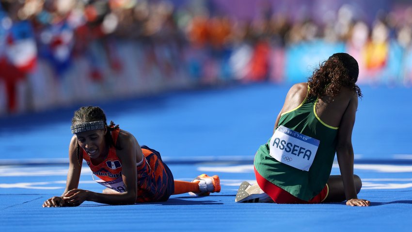 PARIS, FRANCE – AUGUST 11: Sifan Hassan of Team Netherlands and Tigst Assefa of Team Ethiopia react after crossing the finish line during the Women’s Marathon on day sixteen of the Olympic Games Paris 2024 at Esplanade Des Invalides on August 11, 2024 in Paris, France. (Photo by Cameron Spencer/Getty Images)