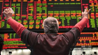 A trader signals an offer in the Standard & Poor’s 500 stock index futures pit at the CME Group in Chicago on Dec. 14, 2010.