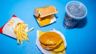 A McDonald’s McDouble cheeseburger, small fries, four-piece chicken nuggets, and a small soft drink arranged in New York, US, on Monday, June 17, 2024. 