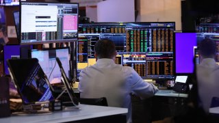 Traders work on the floor of the New York Stock Exchange during morning trading on Aug. 20, 2024.