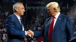 Former Republican presidential candidate Robert F. Kennedy Jr. and Republican presidential nominee, former U.S. President Donald Trump shake hands during a campaign rally at Desert Diamond Arena on August 23, 2024 in Glendale, Arizona.