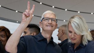 Apple CEO Tim Cook shows a peace sign as Apple holds an event at the Steve Jobs Theater on its campus in Cupertino, California, on Sept. 9, 2024.