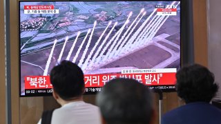 People watch a television screen showing a news broadcast with file footage of a North Korean missile test, at a train station in Seoul on Sept. 12, 2024. North Korea fired multiple short range ballistic missiles into waters east of the Korean peninsula on September 12, Seoul’s military reported, days after the nuclear-armed North marked a state anniversary.