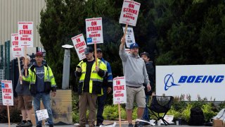 Boeing factory workers gather on a picket line during the first day of a strike near the entrance of a production facility in Renton, Washington, U.S., September 13, 2024. 