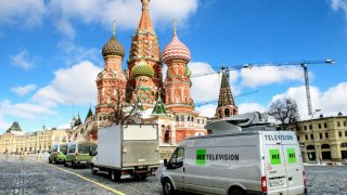 Russian state-controlled Russia Today television broadcast vans parked in front of St. Basil’s Cathedral and the Kremlin next to Red Square in Moscow on March 16, 2018.