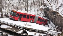 FILE—A Pittsburgh Transit Authority bus sits on the Fern Hollow Bridge in Pittsburgh after it collapsed in this on Jan. 28, 2022.   (AP Photo/Gene J. Puskar, File)