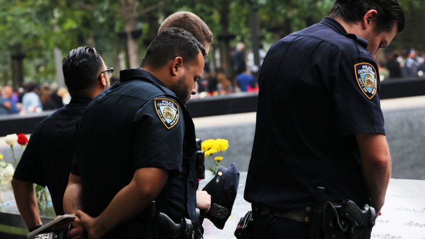 NEW YORK, NEW YORK – SEPTEMBER 11: NYPD officers lower their heads during a moment of silence at the annual 9/11 Commemoration Ceremony at the National 9/11 Memorial and Museum on September 11, 2022 in New York City. This year marks the 21st anniversary of the terror attacks of September 11, 2001, when the terrorist group al-Qaeda flew hijacked airplanes into the World Trade Center, Shanksville, PA and the Pentagon, killing nearly 3,000 people. Vice President Kamala Harris and Secretary of Homeland Security Alejandro N. Mayorkas were in attendance for this year’s ceremony.  (Photo by Michael M. Santiago/Getty Images)