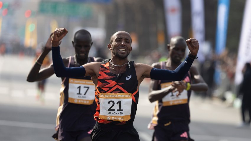 Gold medalist Jemal Yimer Mekonnen C of Ethiopia celebrates as he crosses the finish line during the 2024 Seoul International Marathon in Seoul, South Korea, March 17, 2024. (Photo by Jun Hyosang/Xinhua via Getty Images)