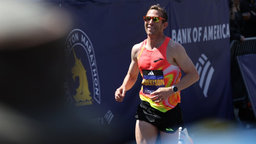 BOSTON, MASSACHUSETTS – APRIL 15: CJ Albertson of the United States crosses the finish line during the 128th Boston Marathon on April 15, 2024 in Boston, Massachusetts.  (Photo by Paul Rutherford/Getty Images)