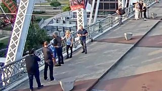 Jon Bon Jovi hugs a woman after helping talk her from a ledge of a pedestrian bridge in Nashville, Tenn., on Wednesday.