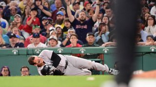 Jun 16, 2024; Boston, Massachusetts, USA; New York Yankees first baseman Anthony Rizzo (48) trips on Boston Red Sox pitcher Brennan Bernardino (not pictured) and rolls on the ground during the seventh inning at Fenway Park. Mandatory Credit: Eric Canha-USA TODAY Sports