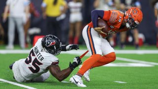 Sep 15, 2024; Houston, Texas, USA; Houston Texans defensive end Danielle Hunter (55) holds onto the jersey of Chicago Bears quarterback Caleb Williams (18) on a play during the fourth quarter at NRG Stadium. Mandatory Credit: Troy Taormina-Imagn Images