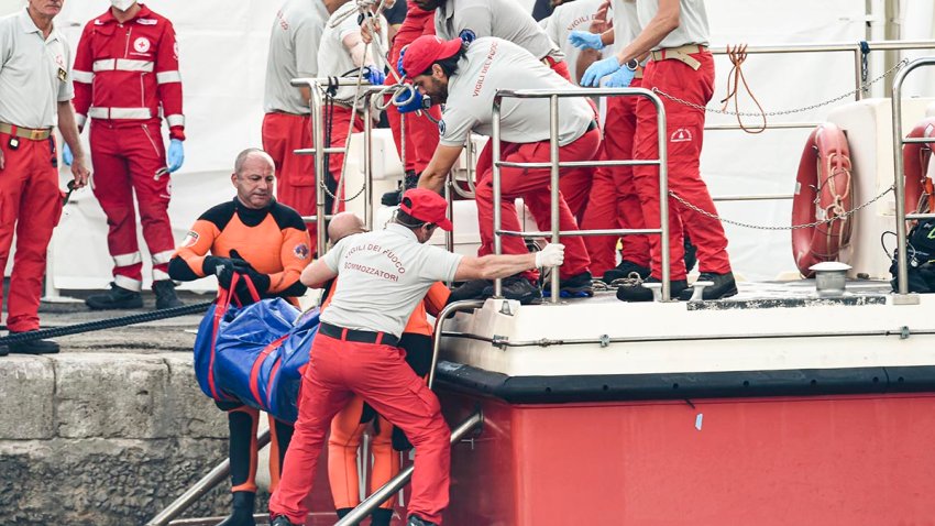 FILE - Italian firefighter divers bring ashore in a plastic bag the body of one of the victims of a shipwreck, in Porticello, Sicily, southern Italy, Thursday, Aug. 22, 2024.