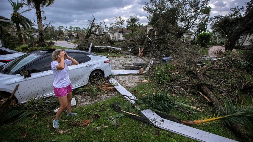 Marie Cook reacts to the damage to her home in the Binks Estates community after a tornado formed by Hurricane Milton touched down striking homes in The Preserve and Binks Estate among others in its path in Wellington, Florida, U.S. October 9, 2024. 