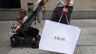 A man with Dior paper bag in Manhattan, New York City, United States of America on July 15th, 2024. 