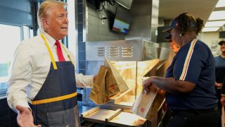 Republican presidential nominee and former U.S. President Donald Trump works behind the counter during a visit to McDonalds in Feasterville-Trevose, Pennsylvania, U.S. October 20, 2024. 