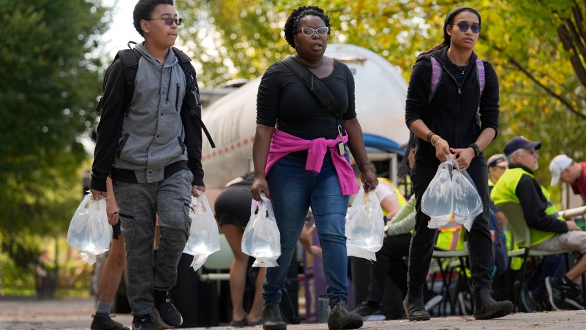 People carry bags of fresh water