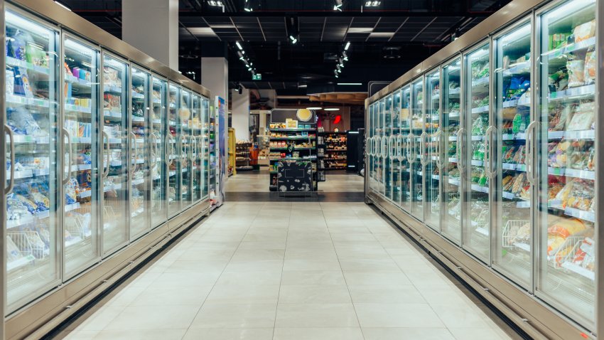 Empty supermarket aisle with freezers showcases with different products