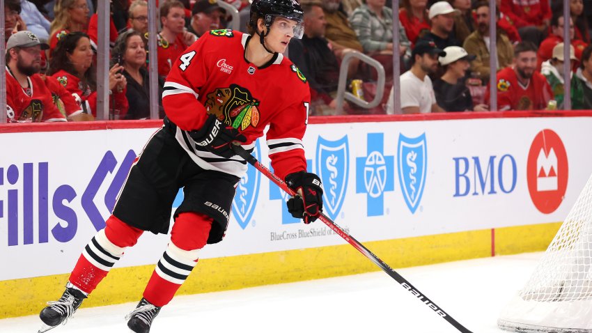 CHICAGO, ILLINOIS – SEPTEMBER 25: Kevin Korchinski #14 of the Chicago Blackhawks skates with the puck against the Detroit Red Wings during the third period of a preseason game at the United Center on September 25, 2024 in Chicago, Illinois.  (Photo by Michael Reaves/Getty Images)