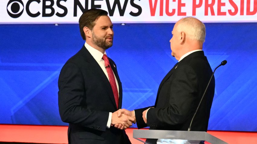 US Senator and Republican vice presidential candidate J.D. Vance and Minnesota Governor and Democratic vice presidential candidate Tim Walz shake hands at the start of the Vice Presidential debate hosted by CBS News at the CBS Broadcast Center in New York City on October 1, 2024. (Photo by ANGELA WEISS / AFP) (Photo by ANGELA WEISS/AFP via Getty Images)