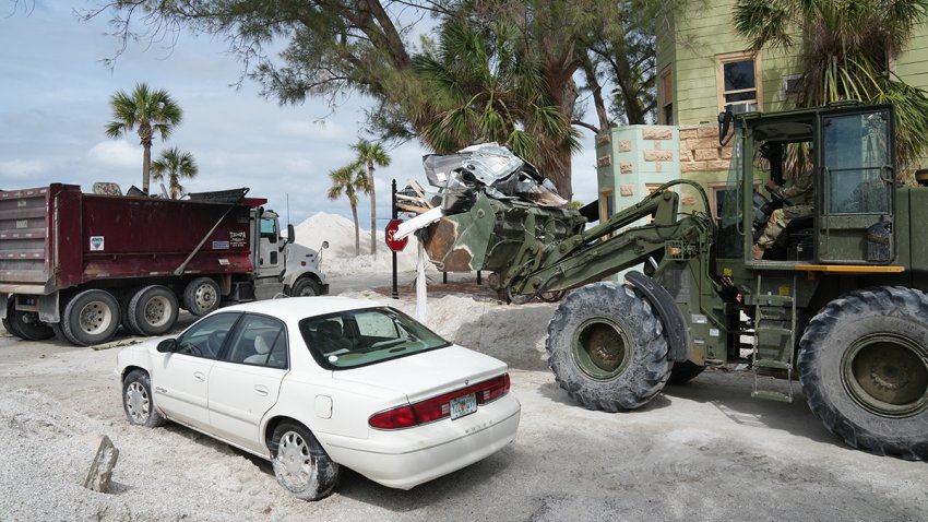 A Florida Army National Guard loader moves debris from the Pass-A-Grille section of St. Petersburg ahead of Hurricane Milton’s expected landfall in the middle of this week on October 7, 2024 in Florida. Florida’s governor has declared a state of emergency on Saturday as forecasters warned that Hurricane Milton is expected to make landfall later this week. (Photo by Bryan R. SMITH / AFP) (Photo by BRYAN R. SMITH/AFP via Getty Images)