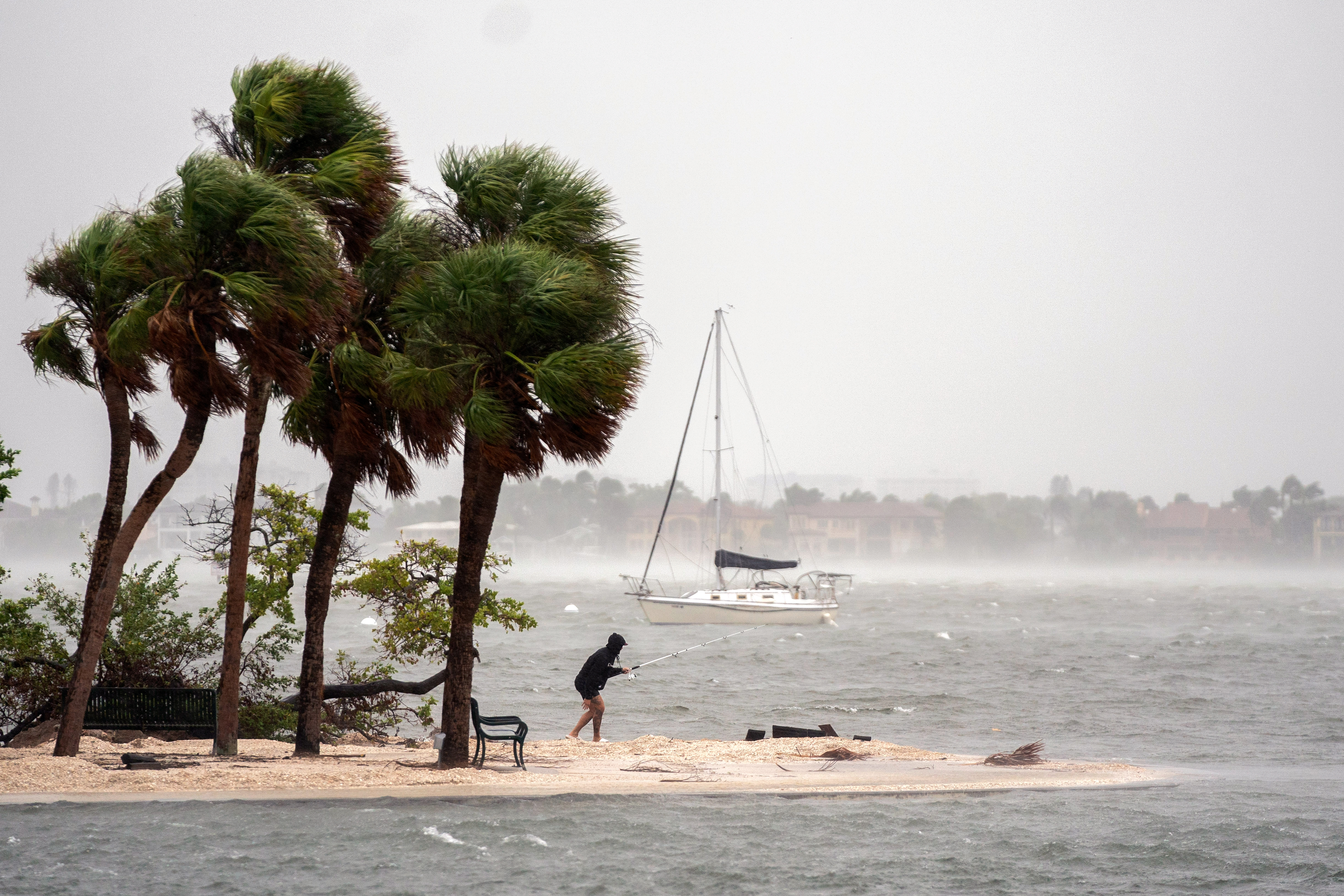 A person fishes as Hurricane Milton approaches on October 9, 2024 in Sarasota, Florida. Milton, which comes just after the recent catastrophic hurricane Helene, will hit Florida’s central Gulf Coast and is expected to make landfall with destructive winds and flooding.