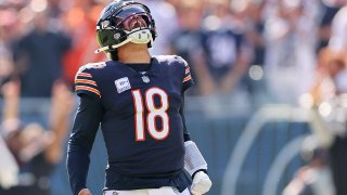 CHICAGO, ILLINOIS – OCTOBER 06: Caleb Williams #18 of the Chicago Bears reacts after throwing a touchdown pass to DJ Moore #2 (not pictured) against the Carolina Panthers during the second quarter  at Soldier Field on October 06, 2024 in Chicago, Illinois. (Photo by Michael Reaves/Getty Images)